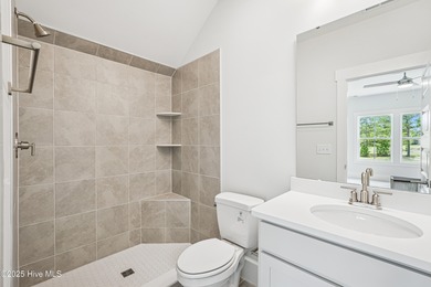 Discover the Skiff, a beautiful new Logan Home, located in on Sea Trail Golf Resort in North Carolina - for sale on GolfHomes.com, golf home, golf lot