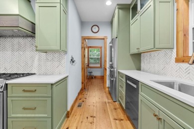 Located in Sapphire Valley, this 3-bedroom, 2.5-bathroom cabin on Sapphire National Golf Club in North Carolina - for sale on GolfHomes.com, golf home, golf lot