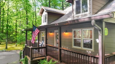 Located in Sapphire Valley, this 3-bedroom, 2.5-bathroom cabin on Sapphire National Golf Club in North Carolina - for sale on GolfHomes.com, golf home, golf lot
