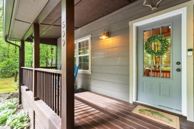 Located in Sapphire Valley, this 3-bedroom, 2.5-bathroom cabin on Sapphire National Golf Club in North Carolina - for sale on GolfHomes.com, golf home, golf lot