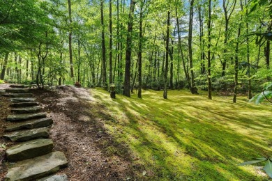 Located in Sapphire Valley, this 3-bedroom, 2.5-bathroom cabin on Sapphire National Golf Club in North Carolina - for sale on GolfHomes.com, golf home, golf lot