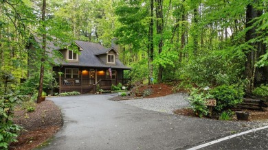 Located in Sapphire Valley, this 3-bedroom, 2.5-bathroom cabin on Sapphire National Golf Club in North Carolina - for sale on GolfHomes.com, golf home, golf lot
