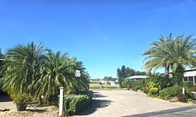 Located on the 15th fairway of the executive golf course at Deer on Deer Creek RV Golf Resort in Florida - for sale on GolfHomes.com, golf home, golf lot