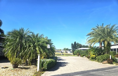 Located on the 15th fairway of the executive golf course at Deer on Deer Creek RV Golf Resort in Florida - for sale on GolfHomes.com, golf home, golf lot