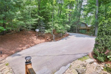 Immersed in tranquility, this three-bedroom, three-bathroom on Sapphire National Golf Club in North Carolina - for sale on GolfHomes.com, golf home, golf lot