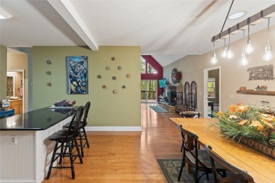 Immersed in tranquility, this three-bedroom, three-bathroom on Sapphire National Golf Club in North Carolina - for sale on GolfHomes.com, golf home, golf lot