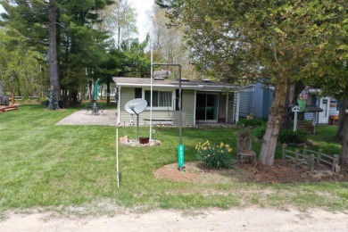 Just in time for summer. This beautiful cottage on a double lot on Huron Shores Golf Club in Michigan - for sale on GolfHomes.com, golf home, golf lot