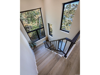 Breathtaking Modern Lakefront Retreat with Boat Slip Welcome to on Indian Hills Country Club in Arkansas - for sale on GolfHomes.com, golf home, golf lot