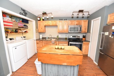 Nestled on a quiet street in the Bay, this charming home sits on on Indian Hills Country Club in Arkansas - for sale on GolfHomes.com, golf home, golf lot