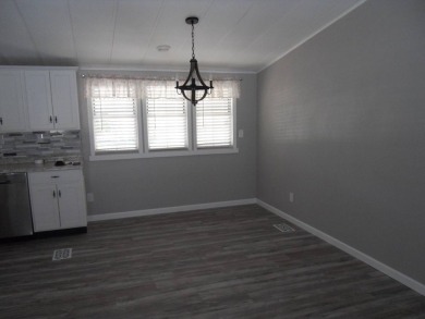 Charming two bedroom, one and a half bathroom home in the Bass on Polo Park East in Florida - for sale on GolfHomes.com, golf home, golf lot
