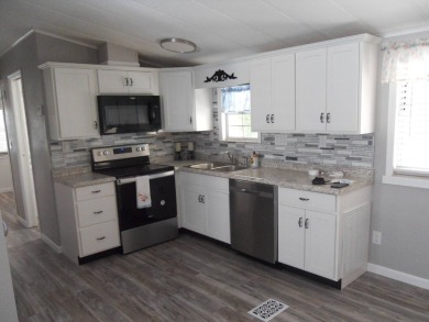 Charming two bedroom, one and a half bathroom home in the Bass on Polo Park East in Florida - for sale on GolfHomes.com, golf home, golf lot