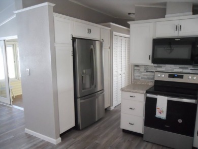 Charming two bedroom, one and a half bathroom home in the Bass on Polo Park East in Florida - for sale on GolfHomes.com, golf home, golf lot