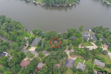 Nestled in the serene community of Hideaway Lake, this charming on Hide-A-Way Lake Golf Course in Texas - for sale on GolfHomes.com, golf home, golf lot