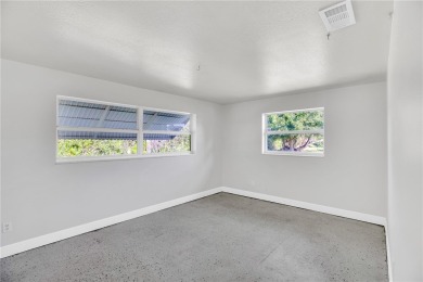 Charming 2-bed, 1-bath home on nearly half an acre (.45+/-) in on Sandridge Golf Course and Club in Florida - for sale on GolfHomes.com, golf home, golf lot