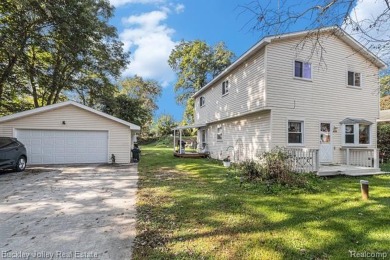 This 2 story colonial on a quarter acre comes with access/lake on Rush Lake Hills Golf Club in Michigan - for sale on GolfHomes.com, golf home, golf lot