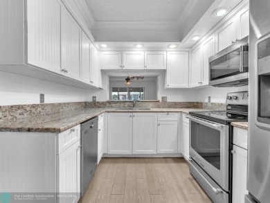 Bright & Clean first-floor 2-bedroom, 1.5-bathroom Waterfront on Flamingo Lakes Country Club in Florida - for sale on GolfHomes.com, golf home, golf lot