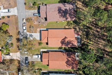 This golf community Florida Home is located on the 11th fairway on The Grand Club - Pine Lakes Course in Florida - for sale on GolfHomes.com, golf home, golf lot