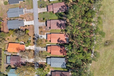 This golf community Florida Home is located on the 11th fairway on The Grand Club - Pine Lakes Course in Florida - for sale on GolfHomes.com, golf home, golf lot