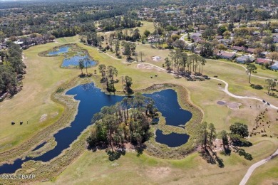 This golf community Florida Home is located on the 11th fairway on The Grand Club - Pine Lakes Course in Florida - for sale on GolfHomes.com, golf home, golf lot
