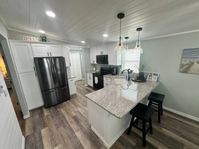 Lot Rent $1037.00 monthly    This beautifully updated home is on Del Tura Golf and Country Club in Florida - for sale on GolfHomes.com, golf home, golf lot