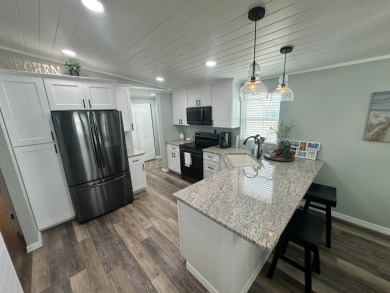 Lot Rent $1037.00 monthly    This beautifully updated home is on Del Tura Golf and Country Club in Florida - for sale on GolfHomes.com, golf home, golf lot