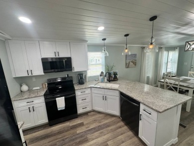 Lot Rent $1037.00 monthly    This beautifully updated home is on Del Tura Golf and Country Club in Florida - for sale on GolfHomes.com, golf home, golf lot