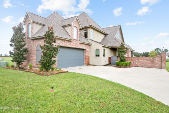 This beautiful 4 bedroom 3 bath home is located on a lake in the on LeTriomphe Golf and Country Club in Louisiana - for sale on GolfHomes.com, golf home, golf lot