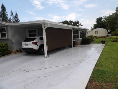 Partially furnished 2 BR 2 BA 14 x 60 mobile home with a 12 X 14 on Crystal Lake Club in Florida - for sale on GolfHomes.com, golf home, golf lot
