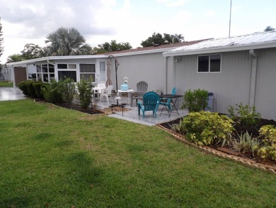 Partially furnished 2 BR 2 BA 14 x 60 mobile home with a 12 X 14 on Crystal Lake Club in Florida - for sale on GolfHomes.com, golf home, golf lot