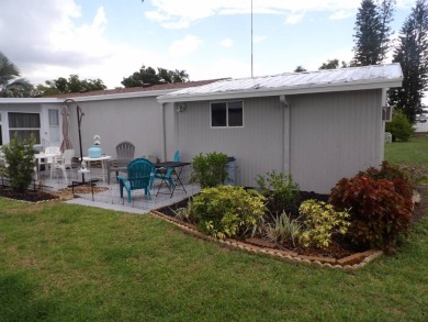 Partially furnished 2 BR 2 BA 14 x 60 mobile home with a 12 X 14 on Crystal Lake Club in Florida - for sale on GolfHomes.com, golf home, golf lot
