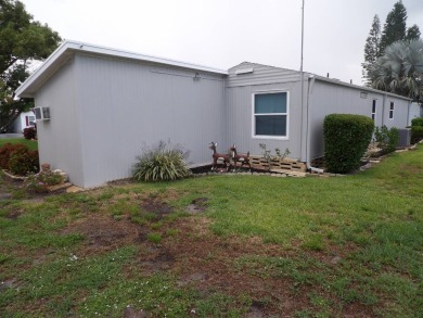 Partially furnished 2 BR 2 BA 14 x 60 mobile home with a 12 X 14 on Crystal Lake Club in Florida - for sale on GolfHomes.com, golf home, golf lot