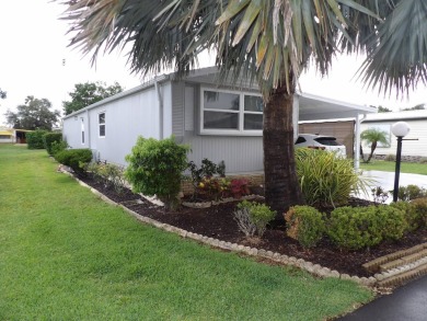 Partially furnished 2 BR 2 BA 14 x 60 mobile home with a 12 X 14 on Crystal Lake Club in Florida - for sale on GolfHomes.com, golf home, golf lot