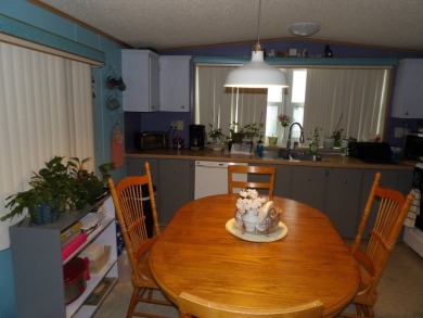 Partially furnished 2 BR 2 BA 14 x 60 mobile home with a 12 X 14 on Crystal Lake Club in Florida - for sale on GolfHomes.com, golf home, golf lot