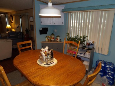 Partially furnished 2 BR 2 BA 14 x 60 mobile home with a 12 X 14 on Crystal Lake Club in Florida - for sale on GolfHomes.com, golf home, golf lot