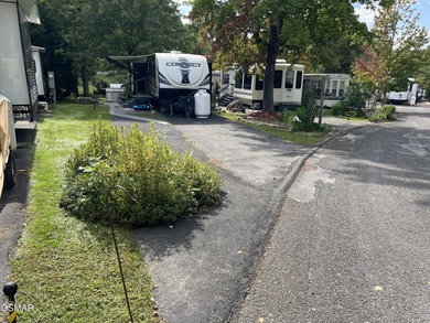 Nice RV lot with plenty of trees, nice patio, and firepit area on Bent Creek Golf Course in Tennessee - for sale on GolfHomes.com, golf home, golf lot