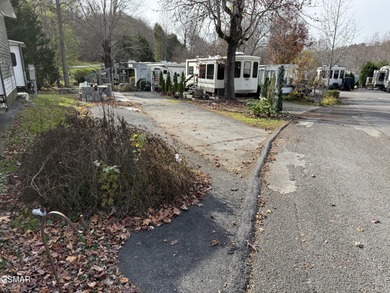 Nice RV lot with plenty of trees, nice patio, and firepit area on Bent Creek Golf Course in Tennessee - for sale on GolfHomes.com, golf home, golf lot