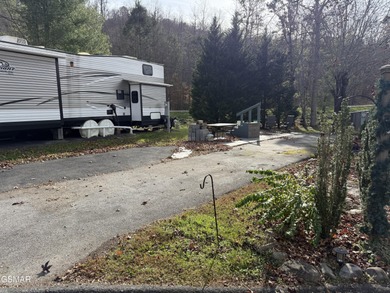 Nice RV lot with plenty of trees, nice patio, and firepit area on Bent Creek Golf Course in Tennessee - for sale on GolfHomes.com, golf home, golf lot
