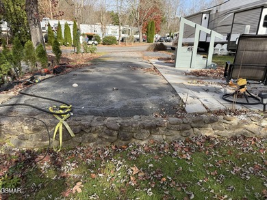 Nice RV lot with plenty of trees, nice patio, and firepit area on Bent Creek Golf Course in Tennessee - for sale on GolfHomes.com, golf home, golf lot