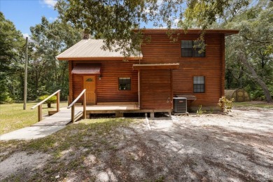 Custom Cypress Log Home Cabin located in the heart of Chiefland on Chiefland Golf and Country Club in Florida - for sale on GolfHomes.com, golf home, golf lot