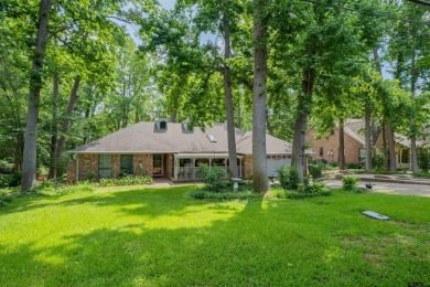 Located in the gated community of Hideaway Lake, this inviting on Hide-A-Way Lake Golf Course in Texas - for sale on GolfHomes.com, golf home, golf lot