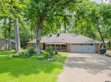 Located in the gated community of Hideaway Lake, this inviting on Hide-A-Way Lake Golf Course in Texas - for sale on GolfHomes.com, golf home, golf lot