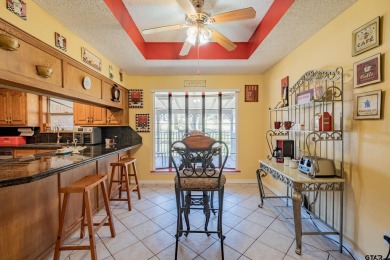 Located in the gated community of Hideaway Lake, this inviting on Hide-A-Way Lake Golf Course in Texas - for sale on GolfHomes.com, golf home, golf lot