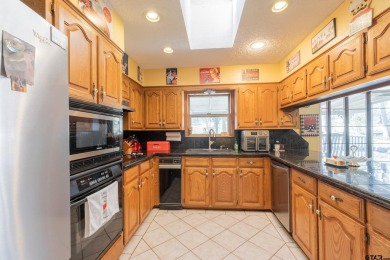 Located in the gated community of Hideaway Lake, this inviting on Hide-A-Way Lake Golf Course in Texas - for sale on GolfHomes.com, golf home, golf lot