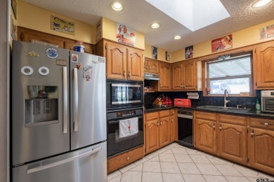 Located in the gated community of Hideaway Lake, this inviting on Hide-A-Way Lake Golf Course in Texas - for sale on GolfHomes.com, golf home, golf lot