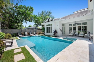 In the heart of the Moorings sits a picture-perfect single story on The Moorings Country Club in Florida - for sale on GolfHomes.com, golf home, golf lot