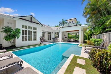 In the heart of the Moorings sits a picture-perfect single story on The Moorings Country Club in Florida - for sale on GolfHomes.com, golf home, golf lot