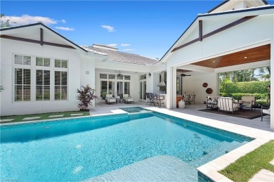 In the heart of the Moorings sits a picture-perfect single story on The Moorings Country Club in Florida - for sale on GolfHomes.com, golf home, golf lot