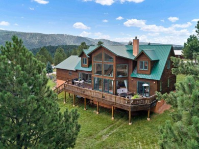 This beautiful two-level mountain chalet is nested among large on Angel Fire Resort Country Club in New Mexico - for sale on GolfHomes.com, golf home, golf lot