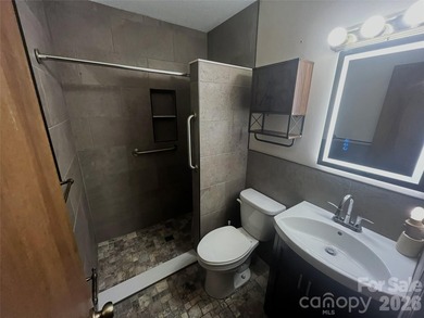 Resort home located at the tip of a quiet cul-de-sac street in on Rumbling Bald Resort on Lake Lure in North Carolina - for sale on GolfHomes.com, golf home, golf lot