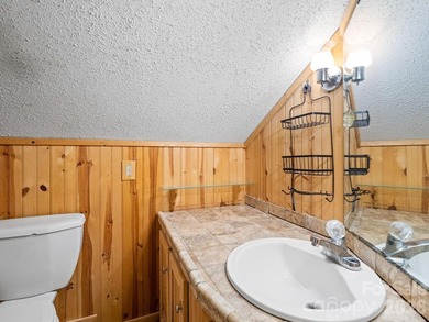 Resort home located at the tip of a quiet cul-de-sac street in on Rumbling Bald Resort on Lake Lure in North Carolina - for sale on GolfHomes.com, golf home, golf lot